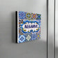 A colorful ceramic tile magnet featuring "ALGARVE" prominently in the center, surrounded by detailed blue, yellow, green, and white patterns with floral designs. Inspired by traditional Portuguese azulejos, this makes for an ideal Algarve souvenir.