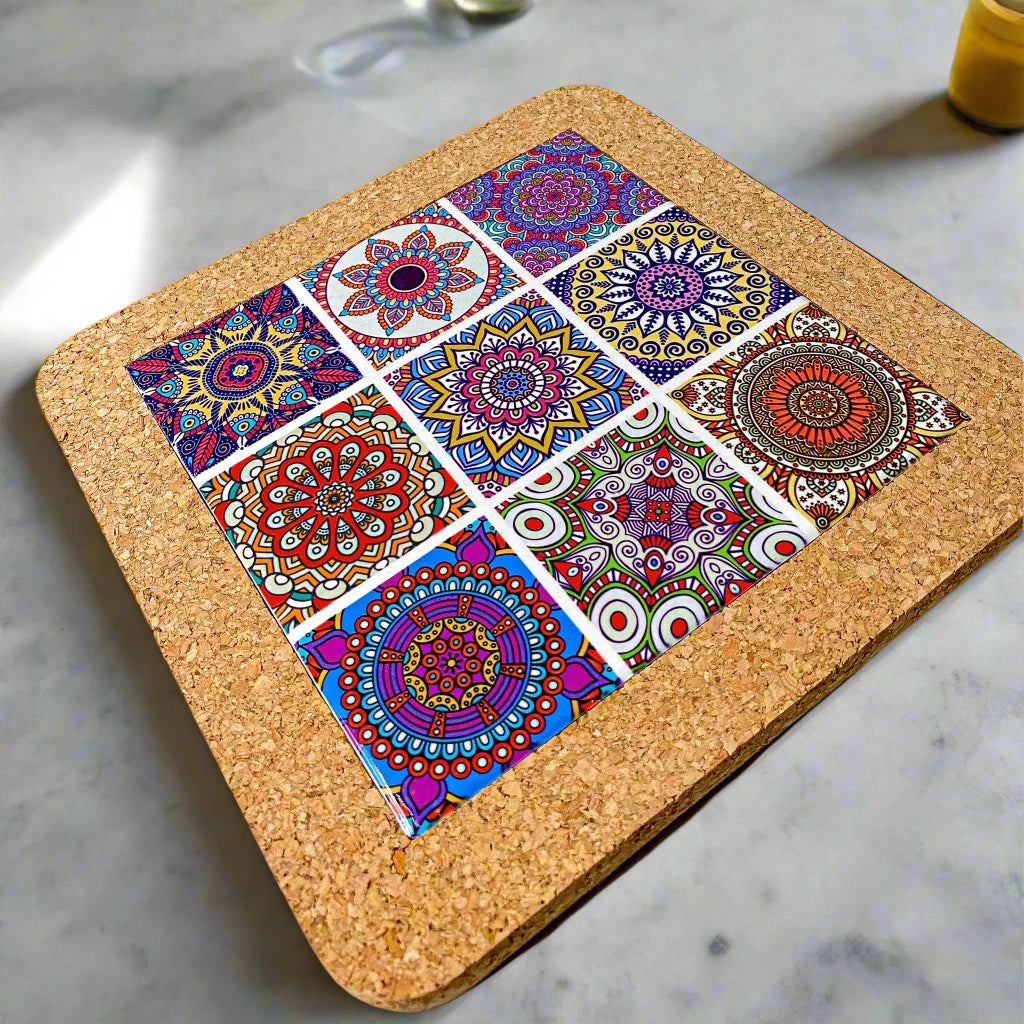 A square cork coaster displaying nine vibrant mandala designs in a 3x3 grid. The detailed mandalas, with their varied colors and patterns, create a lively and artistic effect against the natural cork surface, making it a perfect souvenir.