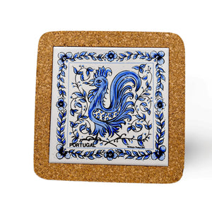 A square cork coaster featuring a blue and white ceramic tile in the center. The tile depicts a detailed, stylized rooster surrounded by ornate floral patterns with the word "Portugal" at the bottom—perfect as a charming Portugal souvenir.