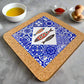 A square cork coaster with a vibrant design, ideal as a Portugal souvenir. The centerpiece features a diamond-shaped section with three decorated fish and the word "Portugal" below. Encircling the diamond is a blue patterned background, reminiscent of traditional Portuguese tiles.