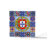 A square mosaic magnet featuring intricate blue, red, yellow, and green tile patterns surrounding the central emblem of Portugal. The emblem includes a shield with five smaller shields arranged in a cross, topped with a yellow border containing red castles—a perfect souvenir from Portugal.