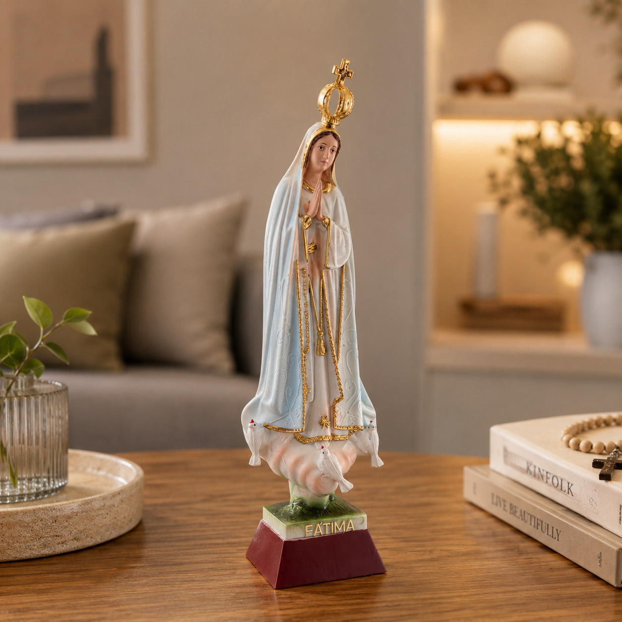 Elegant Our Lady of Fátima souvenir figure displayed on a wooden table, highlighting the detailed white mantle and religious symbolism.
