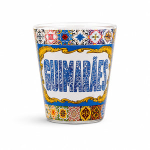 Studio image of Guimarães shot glass souvenir featuring vibrant Portuguese tile artwork and decorative vintage-style frame design