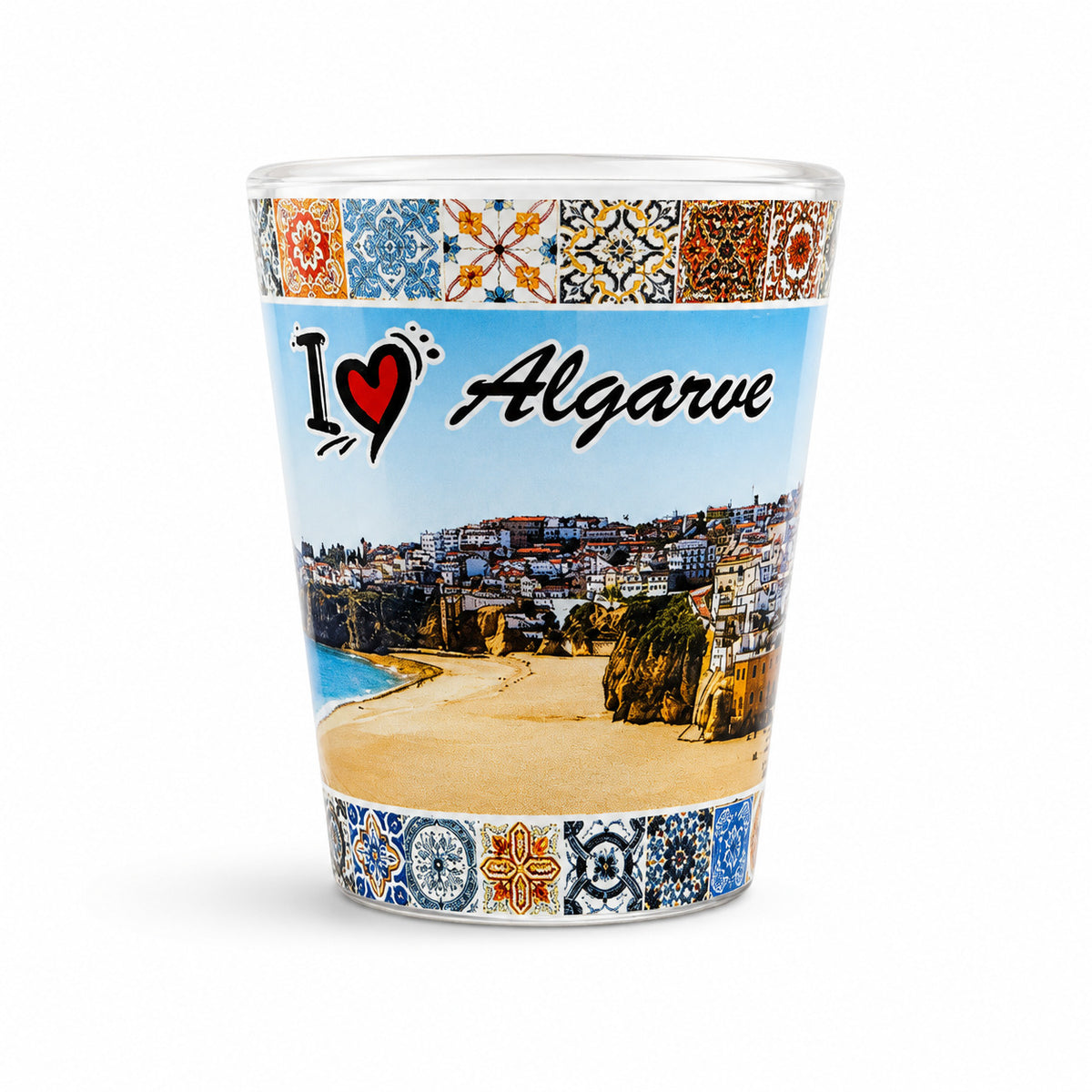 Studio image of Algarve souvenir shot glass decorated with beach panorama artwork, Portuguese tiles, and I Love Algarve design