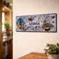 Lisboa metal souvenir sign mounted on a wall featuring Belém Tower, traditional tram and Portuguese azulejos patterns