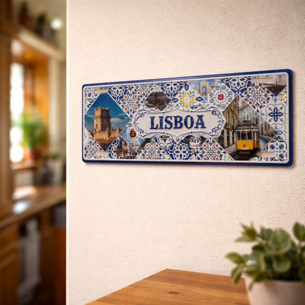 Lisboa metal souvenir sign mounted on a wall featuring Belém Tower, traditional tram and Portuguese azulejos patterns