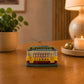 Lisboa yellow tram souvenir replica featuring the famous Lisbon tram design, displayed on a wooden surface with warm ambient lighting.