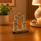 Detailed Lisbon Arco da Rua Augusta souvenir replica displayed on a wooden table, featuring the iconic triumphal arch of Praça do Comércio in a warm home interior.