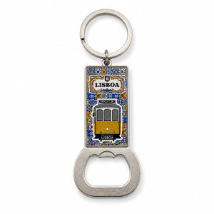 A metal keychain featuring a bottle opener at the bottom and a rectangular enamel tile at the top with a depiction of a Lisbon tram. The word "Lisboa" is written above the tram, surrounded by a decorative blue and yellow border, capturing the charm of Portugal.