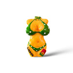 A small magnet featuring a figurine of a bikini girl wearing a green bikini with white polka dots. "LISBOA" is written on the left side of the bottoms, and a tiny Portuguese flag adorns the right. This charming souvenir stands out against its white background.