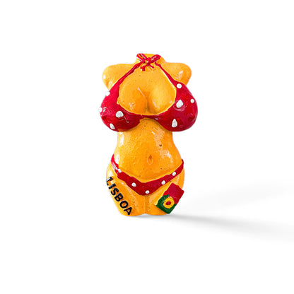 A small figurine magnet of a torso wearing a red polka dot bikini. The bikini bottoms have "Lisboa" written on them with a small flag emblem, celebrating Lisbon. The figure is brightly colored and set against a plain white background.
