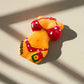 A vibrant magnet featuring a torso figurine dressed in a red polka dot bikini. The bikini bottoms display the word "Lisboa" along with a small flag emblem, celebrating Lisbon. The figurine pops against a simple white background.