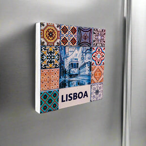 A vibrant collage of traditional Portuguese tiles surrounds a central image of a tram winding through a narrow Lisbon street. The word "LISBOA" is boldly displayed at the bottom. The tiles feature intricate patterns in shades of blue, red, and orange, making this magnet an ideal Portugal souvenir.