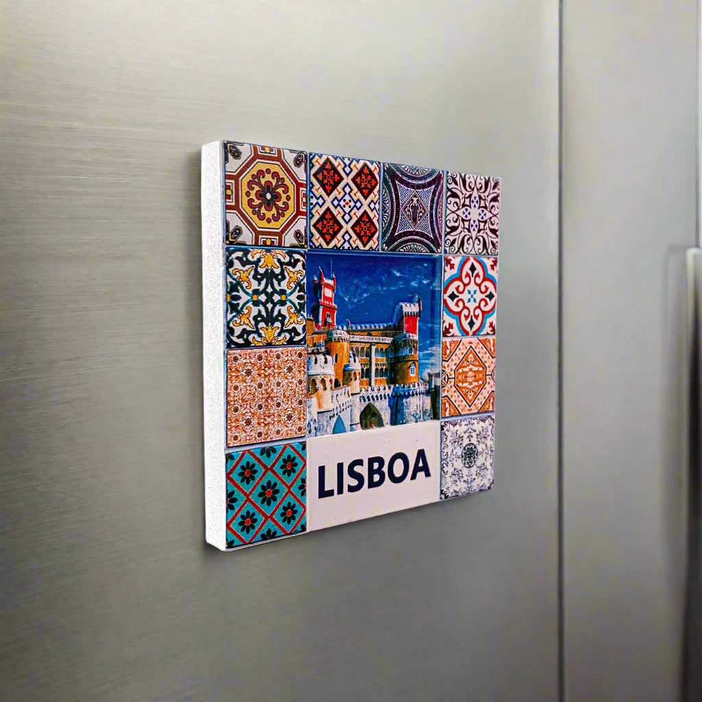 A vibrant square tile magnet showcases Pena Palace in Lisbon, Portugal, as its central image, framed by elaborate, multicolored geometric and floral designs. Beneath the palace, the word "LISBOA" stands out, accompanied by an endearing illustration of a classic tram.