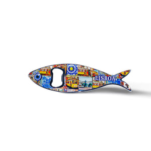 This sardine-shaped metal bottle opener is embellished with colorful, detailed artwork, featuring a well-known Lisbon building and the inscription "Lisboa." The opener hole is located at the fish's eye, adding to the charm of this Portuguese keepsake.
