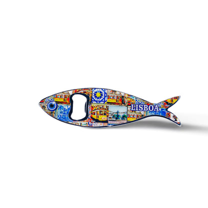 This sardine-shaped metal bottle opener is embellished with colorful, detailed artwork, featuring a well-known Lisbon building and the inscription "Lisboa." The opener hole is located at the fish's eye, adding to the charm of this Portuguese keepsake.