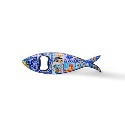 Shaped like a sardine, this metal bottle opener is adorned with vibrant, intricate details, highlighting a landmark building and the text "Lisboa." The opener hole is located where the fish’s eye would be, making this a charming memento from Portugal.