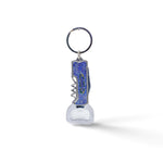 A multi-functional keychain featuring a metal bottle opener and corkscrew. The handle is blue with a textured surface, and the word "LIFEGUARD" is printed on it. The keyring is attached to the top, ready to be connected to a set of keys. Perfect for any adventure from Lisbon to your backyard.