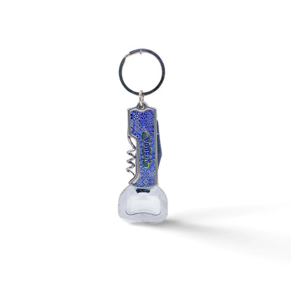 A multi-functional keychain featuring a metal bottle opener and corkscrew. The handle is blue with a textured surface, and the word "LIFEGUARD" is printed on it. The keyring is attached to the top, ready to be connected to a set of keys. Perfect for any adventure from Lisbon to your backyard.