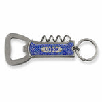 A multi-functional keychain featuring a metal bottle opener and corkscrew. The handle is blue with a textured surface, and the word "LISBOA" is printed on it. The keyring is attached to the top, ready to be connected to a set of keys. Perfect for any adventure from Lisbon to your backyard.
