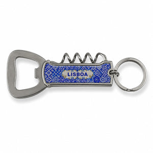 A multi-functional keychain featuring a metal bottle opener and corkscrew. The handle is blue with a textured surface, and the word "LISBOA" is printed on it. The keyring is attached to the top, ready to be connected to a set of keys. Perfect for any adventure from Lisbon to your backyard.