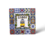 A colorful decorative tile with intricate patterns in blue, yellow, and green surrounds a central image of a yellow tram and the word "LISBOA" above it. This stunning souvenir captures the essence of Portugal, reminiscent of traditional Portuguese azulejos.