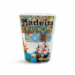 Studio image of Madeira shot glass souvenir decorated with Portuguese tiles, maritime caravels, and vibrant island-themed illustrations