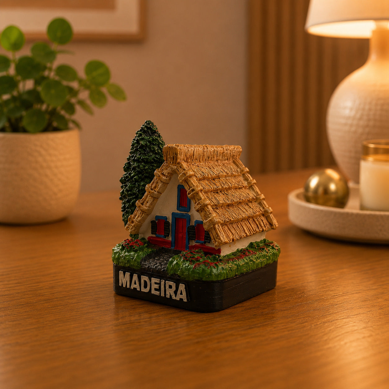 Rear view of a Madeira Santana House souvenir magnet highlighting the traditional triangular architecture and thatched roof construction.