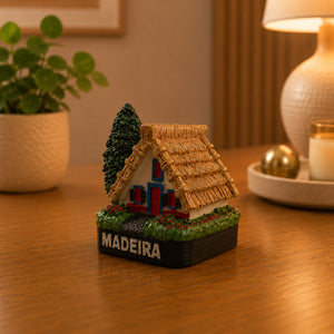 Rear view of a Madeira Santana House souvenir magnet highlighting the traditional triangular architecture and thatched roof construction.