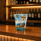 Colorful Madeira souvenir shot glass featuring tropical parrots, traditional houses, ocean wildlife, and Portuguese-inspired decorative patterns