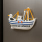Decorative fishing boat magnet with a seagull on a metallic surface