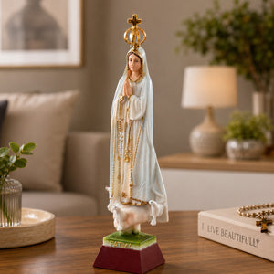 Our Lady of Fátima religious souvenir statue displayed indoors, showcasing detailed craftsmanship, crown, rosary, and traditional Marian design.