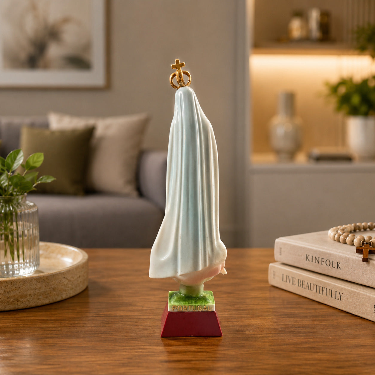 Rear view of an Our Lady of Fátima religious statue souvenir showing the flowing mantle and decorative finish inspired by the Sanctuary of Fátima.