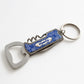 Folded Porto souvenir keychain featuring traditional blue azulejo artwork with integrated bottle opener and corkscrew.
