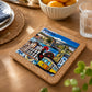 Porto cork base with colorful ceramic azulejo tile placed on a wooden dining table surrounded by Portuguese-inspired kitchen décor.
