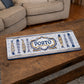 Porto metal souvenir sign placed on a wooden table showing stylized sardines and classic Portuguese tile patterns
