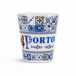 Studio image of Porto souvenir shot glass decorated with blue Portuguese azulejo tiles, sardine illustrations, and traditional Porto artwork