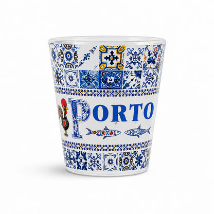 Studio image of Porto souvenir shot glass decorated with blue Portuguese azulejo tiles, sardine illustrations, and traditional Porto artwork