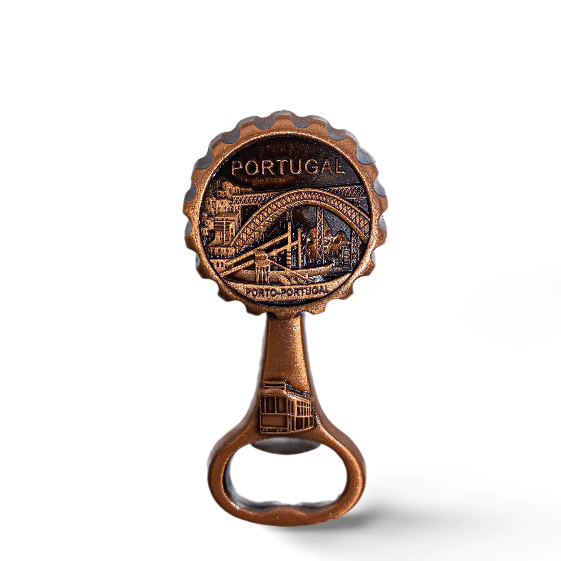 A bronze bottle opener featuring a detailed engraving of the Dom Luís I Bridge in Porto, Portugal. Above the bridge, the word "PORTUGAL" is inscribed. A classic tram is also depicted at the bottom of this souvenir, symbolizing Porto's charm.