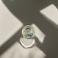 Top view of Portugal azulejo souvenir shot glass with colorful Portuguese tile patterns and artistic shadow reflections on a neutral background.