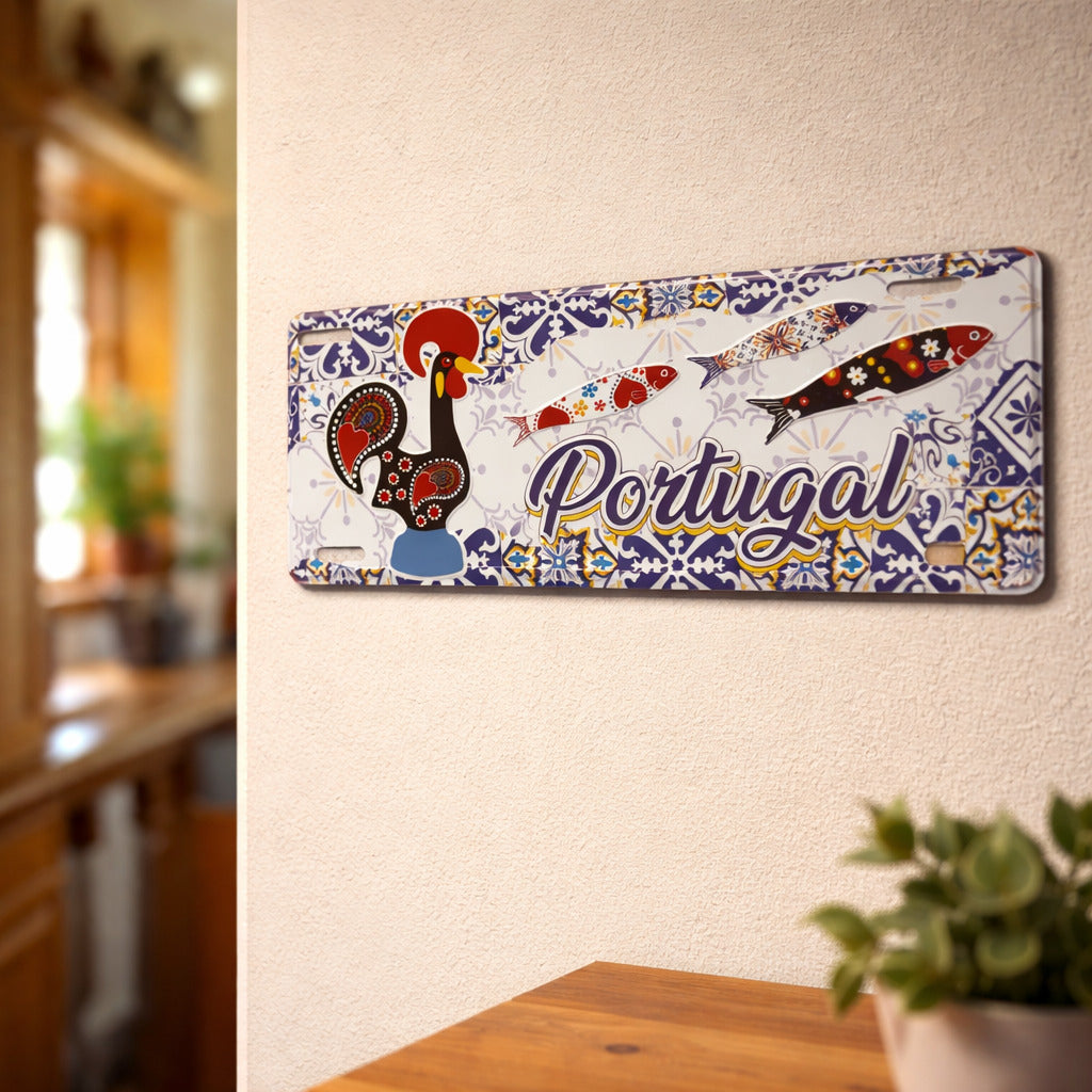 Portugal metal souvenir sign mounted on a wall featuring Barcelos rooster, decorative sardines and traditional azulejos patterns