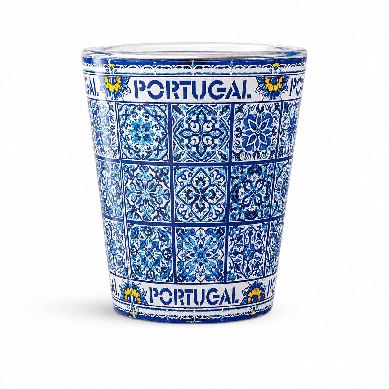 Portugal souvenir shot glass fully decorated with detailed blue Portuguese azulejo tile patterns isolated on white background.
