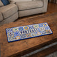 Portugal metal souvenir sign placed on a wooden table featuring traditional Portuguese tile patterns in blue and vibrant colors