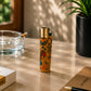 Portugal cork Clipper lighter featuring colourful Barcelos Rooster artwork and traditional Portuguese azulejo patterns displayed on a desk in a warm lifestyle setting with natural light and decorative elements around it.