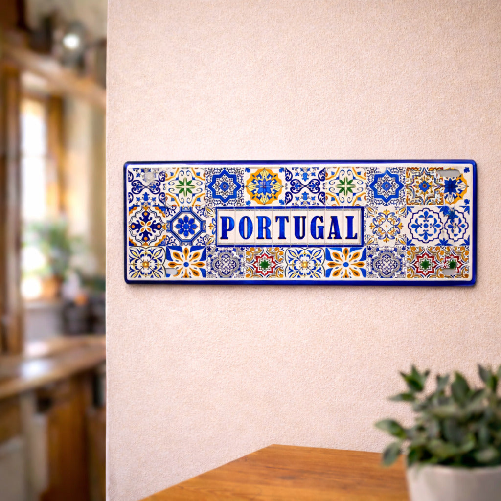 Portugal metal souvenir sign mounted on a wall displaying classic Portuguese azulejos tile designs in blue and multicolor