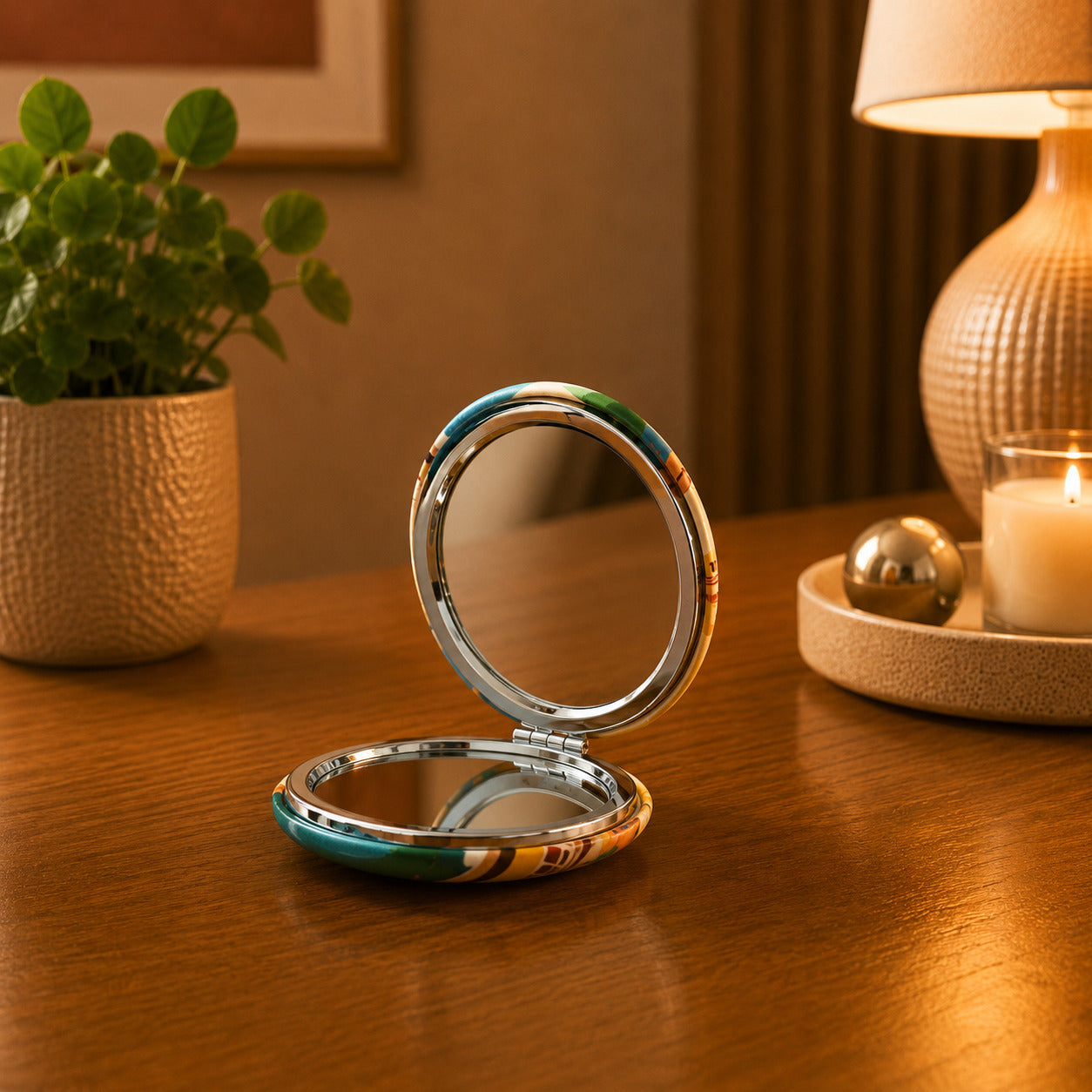 Portugal pocket mirror opened on a wooden table, featuring a colourful Lisbon-inspired design and dual interior mirrors for everyday use.