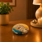 Closed Portugal pocket mirror featuring an illustrated Lisbon cityscape with traditional tram, historic architecture, riverfront scenery, and Portuguese landmarks.