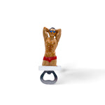Figurine of a muscular man wearing red swim briefs and sunglasses, with hands behind his head, mounted on a white and black bottle opener. This Portugal man serves as a unique souvenir and novelty bottle opener.