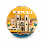 Portugal souvenir pocket mirror isolated on a white background, decorated with colourful artwork of Lisbon landmarks, the iconic yellow tram, and the 25 de Abril Bridge.