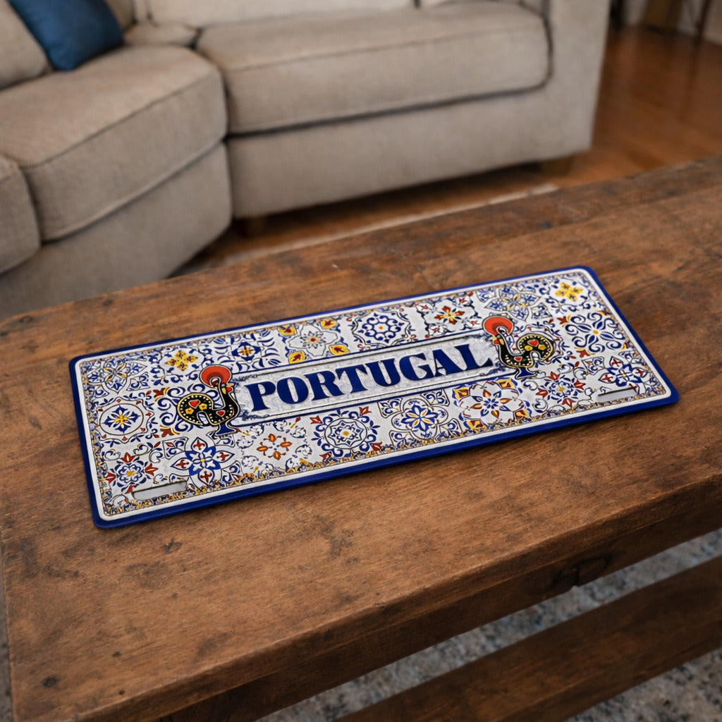 Portugal metal souvenir sign placed on a wooden table featuring classic azulejos patterns and Barcelos rooster illustrations